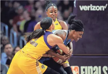  ?? GARY A. VASQUEZ/USA TODAY SPORTS ?? Minnesota Lynx center Sylvia Fowles is defended by Los Angeles Sparks forward Nneka Ogwumike, rear, and forward Candace Parker during the first half of Game 4 of the WNBA Finals on Sunday in Los Angeles.