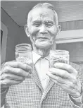  ?? Houston Chronicle file photo ?? Kiyoaki Saibara of Webster, a Harris County rice pioneer, displays samples of past crops.