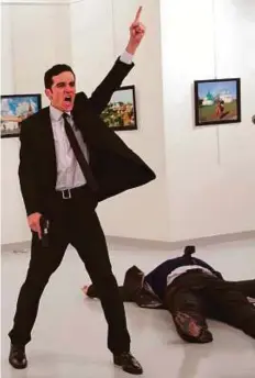  ?? AP ?? Mevlut Mert Altintas after shooting Andrei Karlov, the Russian ambassador to Turkey, on December 19, 2016. AP photograph­er Ozbilici won the 2017 World Press Photo Award for this image.