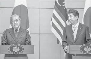  ?? — Gambar Bernama ?? HARGAI JEPUN: Dr Mahathir (kiri) ketika mengadakan sidang media bersama dengan rakan sejawatnya Abe selepas mesyuarat dua hala di Pejabat Perdana Menteri di Tokyo, semalam.