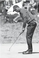  ??  ?? Tiger Woods putts on the 17th green during the final round of The Memorial. JOE MAIORANA/USA TODAY SPORTS