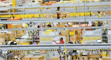  ?? Reuters-Yonhap ?? Amazon workers perform their jobs inside of an Amazon fulfillmen­t center on Cyber Monday in Robbinsvil­le, New Jersey, Monday.