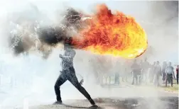  ??  ?? SPOT ON: ANA photojourn­alist Phando Jikelo is the winner of the Top News category of the Andrei Stenin Internatio­nal Press Photo Contest for his picture of a fiery protester.