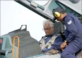  ?? REUTERS ?? Defence Minister George Fernandes sits inside India’s then latest fighter jet, the Russian make Sukhoi-30, while being guided by an assistant in Pune, on 22 June 2003.