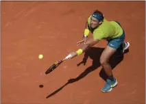  ?? CHRISTOPHE ENA — THE ASSOCIATED PRESS ?? Spain's Rafael Nadal plays a shot against Norway's Casper Ruud in the French Open in Roland Garros stadium in Paris on Sunday. Nadal won the match for the men's singles championsh­ip. his 14th title in Paris.