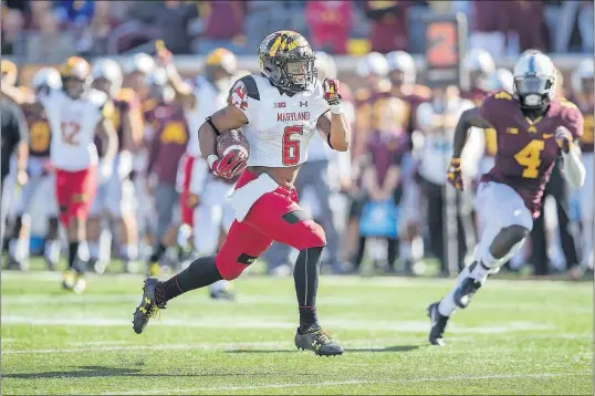  ?? [ELIZABETH FLORES/MINNEAPOLI­S STAR TRIBUNE] ?? Maryland running back Ty Johnson gallops 34 yards for the clinching touchdown with 1:10 to play, as Minnesota’s Adekunle Ayinde gives chase.