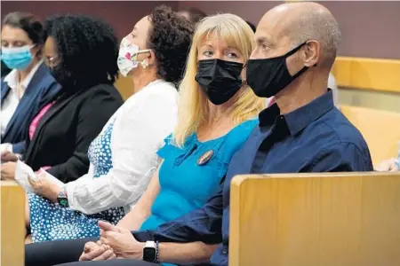  ?? AMY BETH BENNETT/SOUTH FLORIDA SUN SENTINEL ?? Annika Dworet looks at her husband, Mitch Dworet, at the Broward County Courthouse in Fort Lauderdale on Friday as Parkland school shooter Nikolas Cruz enters the courtroom to plead guilty on all four criminal counts stemming from his alleged attack on Sgt. Ray Beltran, a Broward County jail guard, in November 2018.