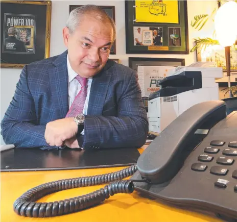  ?? Picture: GLENN HAMPSON ?? Mayor Tom Tate waits by the phone for a call from Scott Morrison or Bill Shorten about light rail funding.