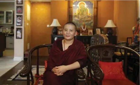  ?? NIRANJAN SHRESTHA PHOTOS/THE ASSOCIATED PRESS ?? Despite her musical fame, Drolma looks every bit the typical Nepalese Buddhist nun, with her hair shaved short and an ever-present smile.