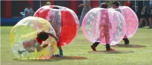 ??  ?? Kids are seen having fun in mini zorbs, which enable them to roll and play without getting injured.