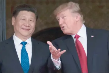  ?? — AFP file photo ?? This photo taken on April 7, 2017 shows US President Donald Trump (R) welcoming Chinese President Xi Jinping to the Mar-a-Lago estate in West Palm Beach, Florida.