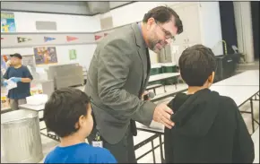  ??  ?? Lawrence Elementary Principal Juan Carlos Villafana works the lunch period for first and second graders at the Lodi school Tuesday. Villafana as was honored as “Boss of the Year” during the Lodi Unified school board meeting Tuesday night.