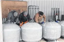  ??  ?? Ryan Mackay (far right), project manager with Aqua Production Systems leads a team preparing components for the Smart Water filtration system.