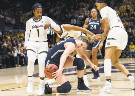  ?? John Hefti / Associated Press ?? UConn’s Katie Lou Samuelson, center, loses possession after colliding with California guard Asha Thomas (1) and forward Alaysia Styles on Saturday in Berkeley, Calif.