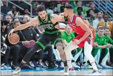  ?? GERALD HERBERT/AP PHOTO ?? Boston Celtics forward Jayson Tatum works against New Orleans Pelicans guard CJ McCollum in Saturday’s game in New Orleans.