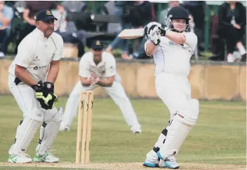  ??  ?? Explosive: Chris Dennison in last year’s Parish Cup final win over Jer Lane