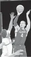  ?? CHARLES REX ARBOGAST/ ASSOCIATED PRESS ?? Connecticu­t’s Tyrese Martin, right, shoots over DePaul’s Romeo Weems during Monday night’s game.