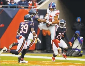  ?? Paul Sancya / Associated Press ?? New York Giants wide receiver Golden Tate (15) makes a catch for a touchdown over Chicago Bears cornerback Buster Skrine (24) during the second half in Chicago on Sunday. Tate is in the concussion protocol.