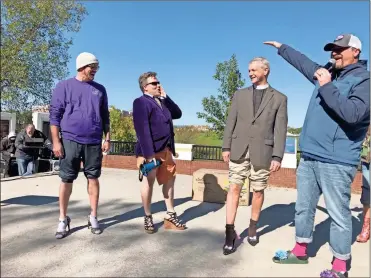  ?? K.T. Mckee ?? Father John Herring of St. Peter’s Episcopal Church is declared the winner of the “hottest legs” contest by cheers from the crowd gathered for the 12th annual “Walk a Mile in Her Shoes” event Friday to raise awareness about domestic violence. Herring, who said the church has financiall­y supported the Hospitalit­y House for Women in Rome for many years, won a fire pit donated by Lowe’s.