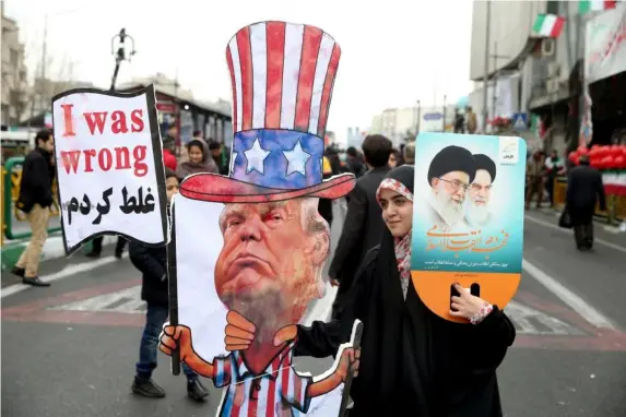  ??  ?? Iranian woman holds effigy of Donald Trump during rally in Tehran (AP)