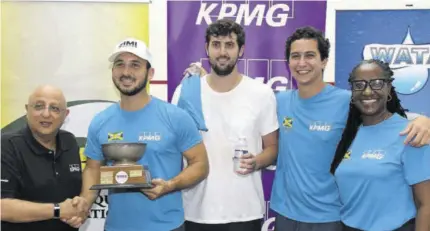  ?? ?? Tarun Handa (left), senior partner at KPMG, presents the winners’ trophy to Blown team member Anthony Mahfood (second left), as teammate Andrew Bicknell (centre) and Captain Jake Mahfood (second right) and Jamaica Squash President Karen Anderson look on at Liguanea Club in New Kingston recently.