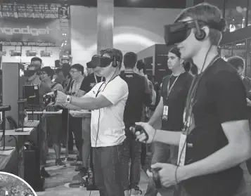  ??  ?? Gaming fans wearing VR headsets play Echo Arena from Oculus at the E3 conference in Los Angeles.