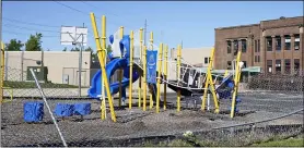  ?? ASSOCIATED PRESS FILE ?? Flowers are placed as a memorial at a playground where a car driven by a slain Cleveland police detective came to rest after being shot the night before in Cleveland in September 2020.