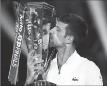  ?? AP ?? Novak Djokovic kisses the ATP Tour Finals trophy on Sunday.