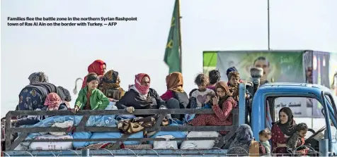  ??  ?? Families flee the battle zone in the northern syrian flashpoint town of ras al ain on the border with Turkey. — aFp