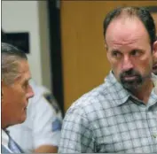  ?? AP FILE ?? John Bittrolff, right, listens to his attorney, William Keahon, during his arraignmen­t on murder charges three years ago in a Long Island court.