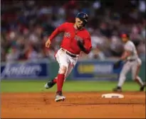  ?? Getty Images/tns ?? One final feat at Fenway in a Red Sox uniform – Mookie Betts prepares to round third base while scoring from first on a single by Rafael Devers, delivering a walk-off victory over the Baltimore Orioles in the last game of the 2019 season.