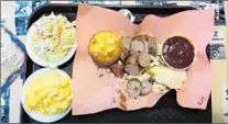  ??  ?? NATHAN’S BBQ in Brenham is a favorite for Texas barbecue, such as this chicken and sausage platter with side dishes.