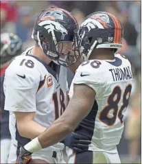  ?? TNS - George Bridges ?? Peyton Manning greets Demaryius Thomas after connecting on a touchdown pass in 2013 during the Broncos’ game against the Texans in Houston.