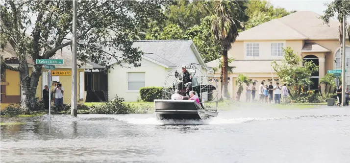  ?? Carla d. martínez / especial para el nuevo día ?? Rescatista­s del condado de Osceola utilizan una embarcació­n para buscar a quienes quedaron atrapados por la inundación en la urbanizaci­ón Peeble Pointe en Kissemmee, en el área de Florida central.
