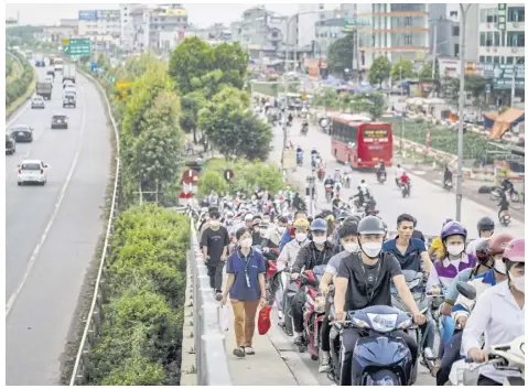  ?? NYT ?? Workers head to work at Van Trung industrial park in Bac Giang province, Vietnam, last August.