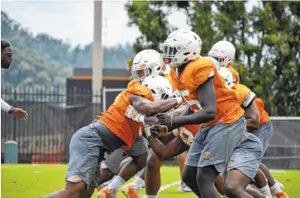  ?? STAFF PHOTO BY DAVID COBB ?? Tennessee defensive linemen work through a drill Tuesday at Haslam Field in Knoxville. First-year Vols head coach Jeremy Pruitt knows he needs the team’s quartet of senior defensive linemen — Paul Bain, Alexis Johnson, Kyle Phillips and Shy Tuttle — to...