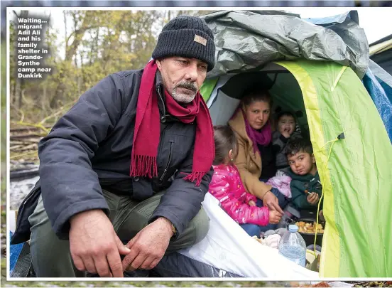  ?? ?? Waiting... migrant Adil Ali and his family shelter in GrandeSynt­he camp near Dunkirk