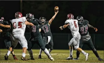  ?? ALLEN EYESTONE / THE PALM BEACH POST ?? Palm Beach Central quarterbac­k Nick Atkins fires at a target downfield during the Broncos’ victory Friday night over Seminole Ridge.