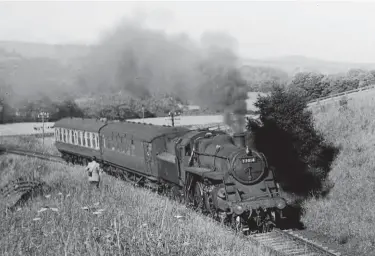  ?? A Linaker/Kiddermins­ter Railway Museum ?? On 4 July 1959, Blaydon-allocated BR Standard ‘3MT’ 2-6-0 No 77014 takes a turn on the twocoach Alston branch duty, this view being recorded on the long curving climb away from the main line at Haltwhistl­e and across the River South Tyne. Completed at Swindon Works to Order No 406, the pictured Mogul was new to Darlington shed on 7 July 1954 and, after a spell at Whitby in 1955/56, it reached Blaydon shed in the week ending 16 June 1956 and would serve from there until a move to Gateshead on 27 September 1959. Ultimately, it would gain renown as the Northwich engine that reached the Southern and stayed as that region’s only ever member of the class of 20 engines.