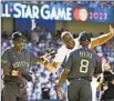  ?? Wally Skalij Los Angeles Times ?? MAGIC JOHNSON greets AL manager Dusty Baker, left, and coach Gary Pettis.