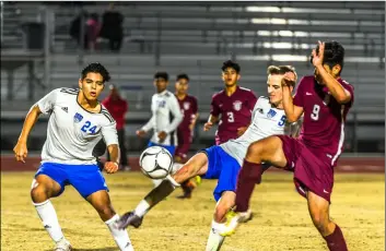  ?? PHOTO VINCENT OSUNA ?? Central Union High’s Isaiah Wood (middle) fights for possession against Calexico High’s Christian Quijada (right) during the Spartans’ away game against Calexico on Tuesday night.