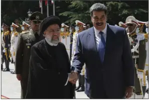  ?? (AP/Vahid Salemi) ?? Venezuela’s President Nicolas Maduro (right) is welcomed by his Iranian counterpar­t Ebrahim Raisi on Saturday at the Saadabad Palace in Tehran, Iran.
