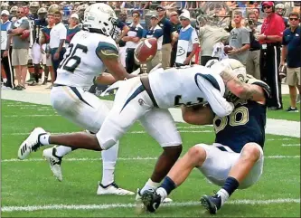  ?? / AP-Keith Srakocic ?? Georgia Tech defensive back Malik Rivera, left, intercepts a pass to Pittsburgh tight end Tyler Sear, right, as defensive back Ajani Kerr defends in the third quarter of the game in Pittsburgh on Saturday.