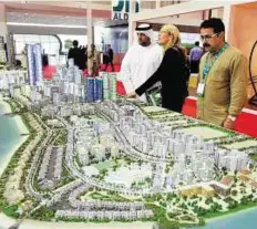  ?? Abdul Rahman/ Gulf News ?? Project layout Mohammad Abdul Hakeem, Chairman of Le- Vallee Retreats, Wayanad, and other guests look at the project of Najmat Abu Dhabi by Reem Developers in Reem Island.