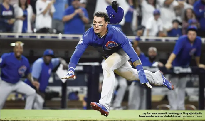  ?? DENIS POROY/GETTY IMAGES ?? Javy Baez heads home with the winning run Friday night after the Padres made two errors on his steal of second.