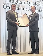  ?? PAKISTANI EMBASSY TO THAILAND ?? Pakistani Ambassador Asim Iftikhar Ahmad, right, presents the Tamgha-i-Quaidi-Azam, or Quaid-i-Azam Medal award to Senator Anumat Amat for his exemplary public service, social work and the promotion of Pakistan-Thai relations.