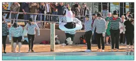  ?? PHOTOS BY ANDREA BRUNER/CONTRIBUTI­NG PHOTOGRAPH­ER ?? Brandt McDonald goes in with a giant unicorn floaty at the Polar Plunge on Feb. 1 at the Batesville Aquatics Center. He was part of Team First Community Bank, which also won the costume contest (bank robbers) in the team division. With 14 plungers, the team tied with Citizens Bank in the Battle of the Banks. Together, participan­ts raised more than $11,000 for Special Olympics Arkansas. See more photos at arkansason­line.com/galleries/categories/threeriver­s.