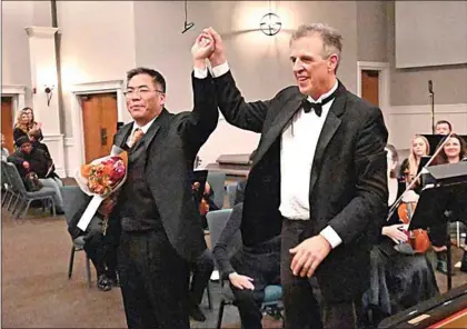  ?? NICK SMIRNOFF / FOR TEHACHAPI NEWS ?? Guest pianist Rufus Choi and conductor David Newby accept the audience’s standing ovation.