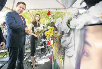  ?? STEPHEN M. DOWELL/TNS ?? Florida Gov. Ron DeSantis and his wife, Casey, carry flowers to the site of the Pulse nightclub in Orlando on June 12, 2019, marking the three-year remembranc­e of the mass shooting that killed 49 people, many Hispanic and LGBTQ. Just days from the five-year remembranc­e of Orlando’s Pulse nightclub massacre, DeSantis on Wednesday vetoed $150,000 in state funds that would have provided counseling for survivors — despite a budget that has $9.5 billion in reserves.