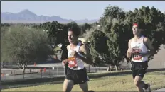  ??  ?? TOP: KOFA RUNNERS MATTHEW LOPEZ (LEFT) AND GAEL GONZALEZ pass through Smucker Memorial Park during Wednesday’s district meet.